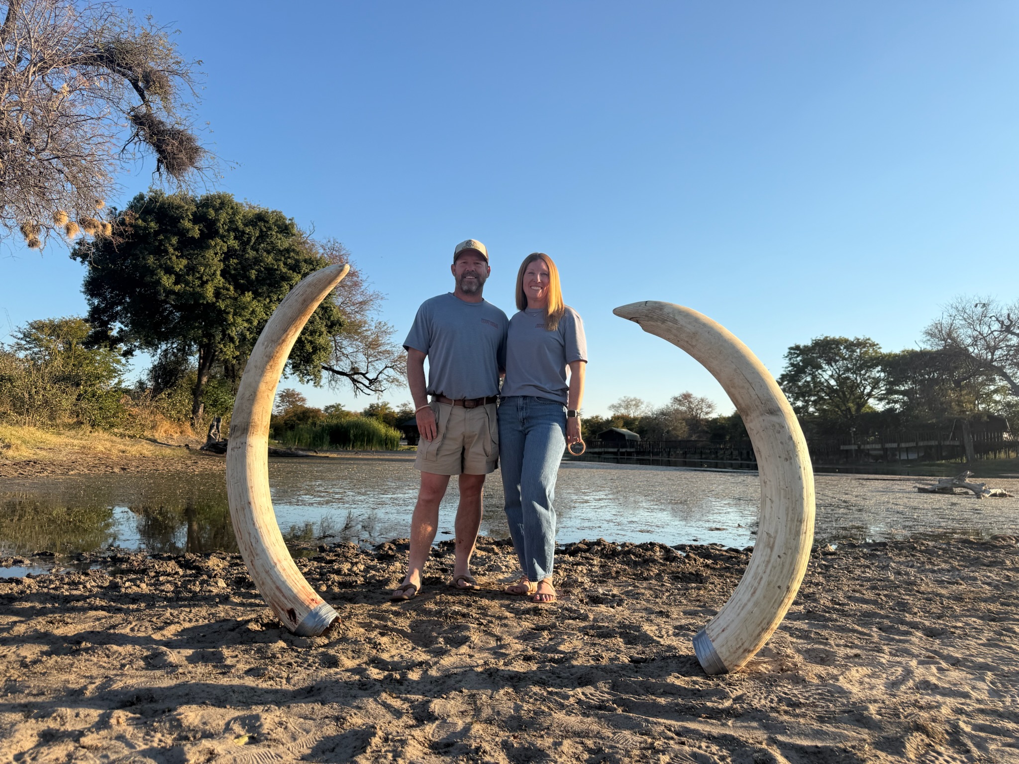 Cindy and Fransua with elephant tusks at the lodge
