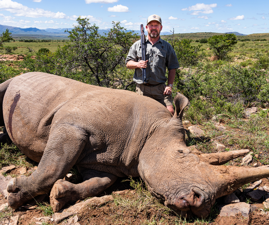 Robert Beall with a white rhino